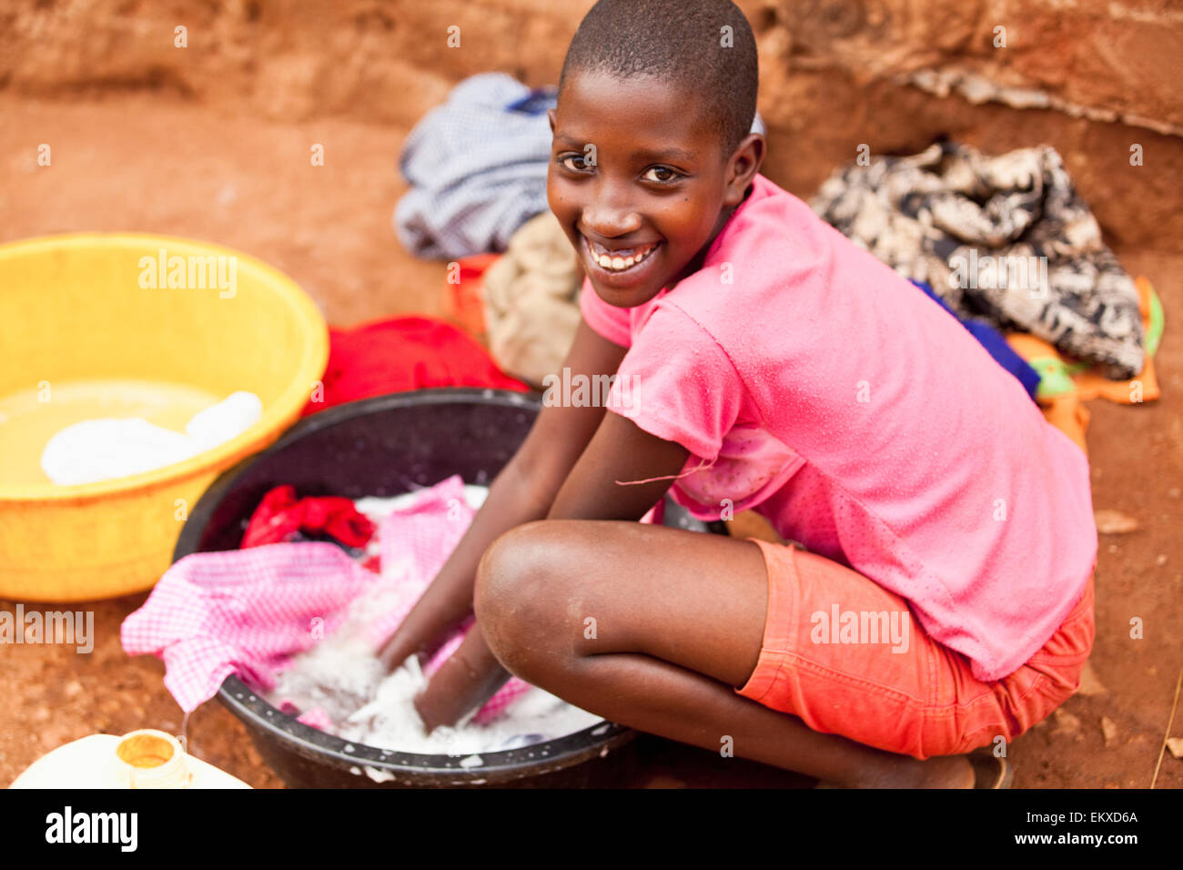 A Young Woman Washing Clothes In A Basin; Kampala Uganda Africa Stock