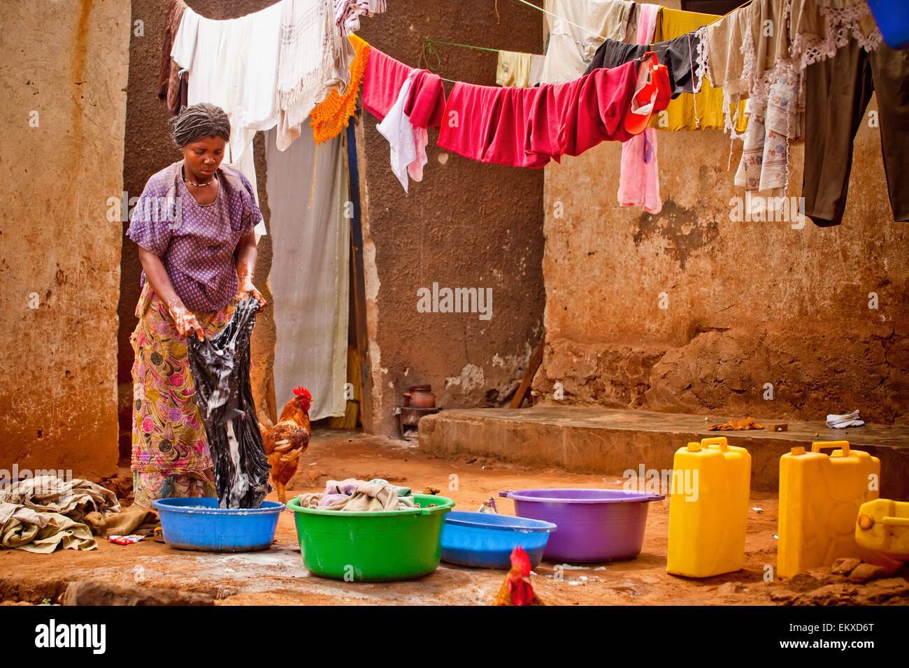 A Woman Washing Clothes In A Basin; Kampala Uganda Africa Stock Photo
