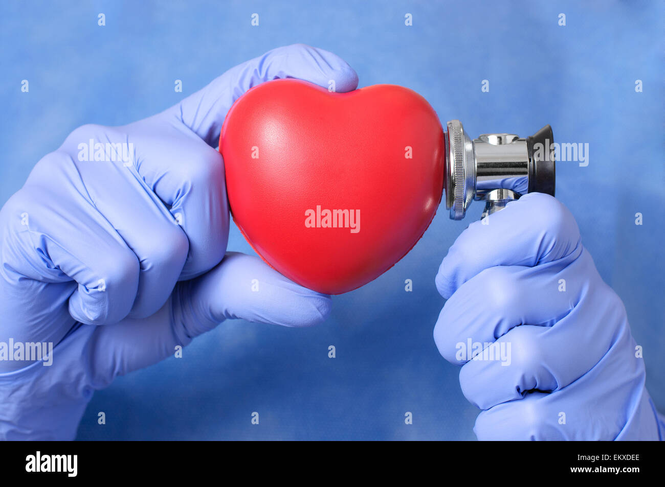 Red heart and stethoscope in the hand of a doctor Stock Photo