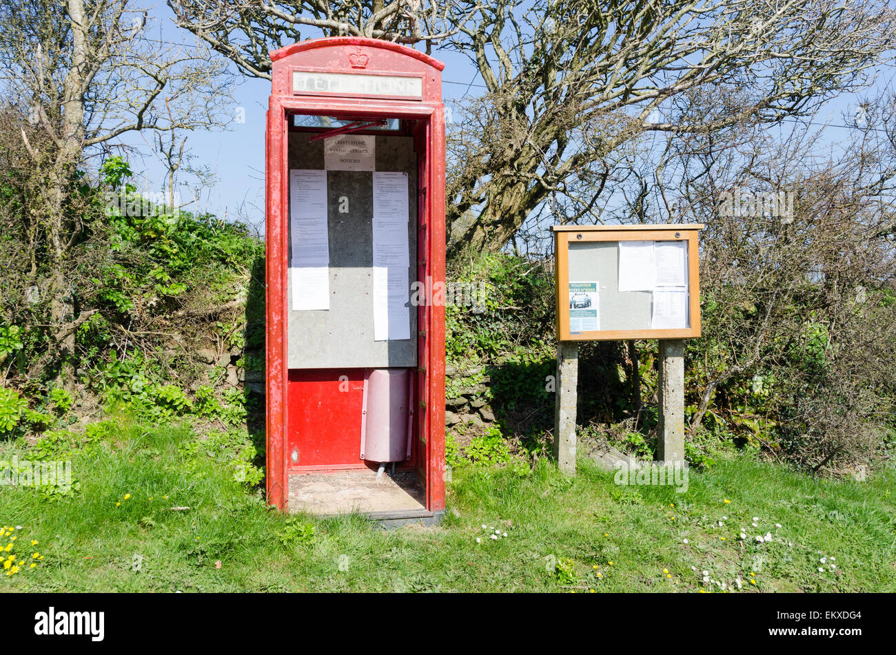 Old telephone box used for parish council notices in the Devon village of East Prawle Stock Photo