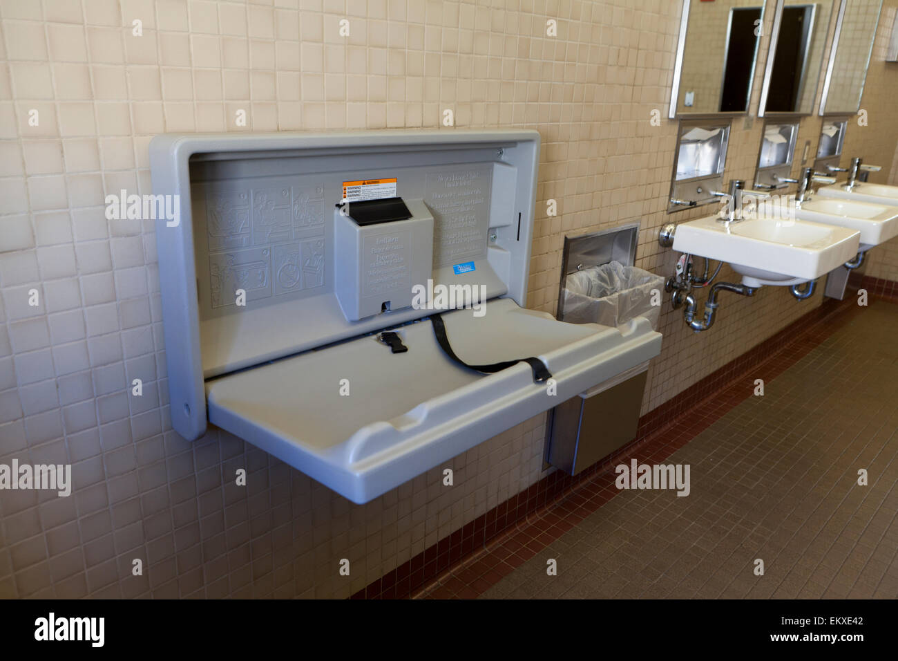 Folding baby changing table in public restroom - USA Stock Photo