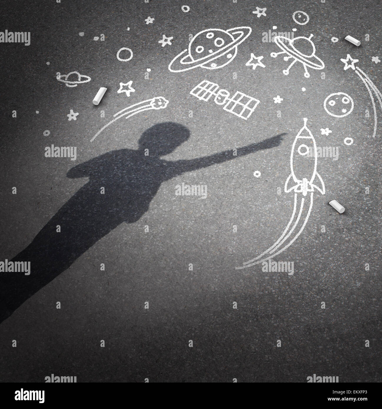 Child space dream as a childhood imagination concept with a cast shadow of a kid dreaming of being an astronaut or astronomy explorer with chalk drawings of a rocket spacecraft planets stars and a flying saucer. Stock Photo
