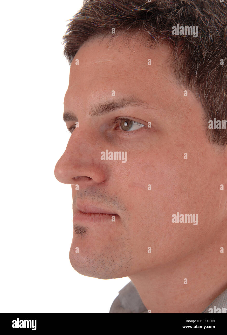 A closeup head shoot in profile of a handsome young man, isolated for ...