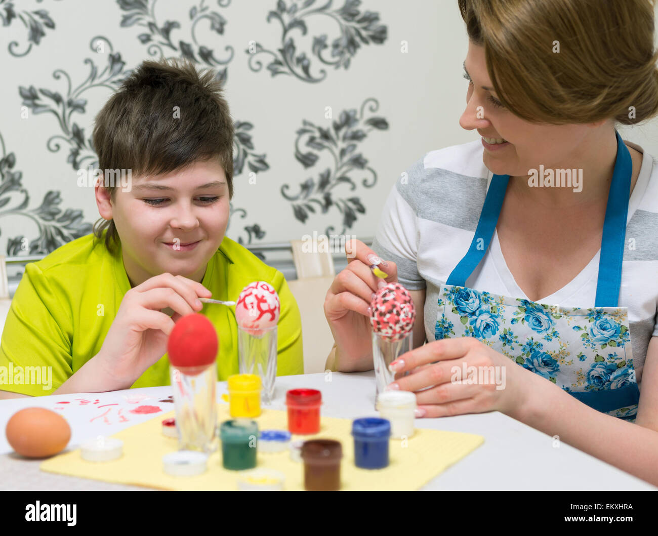 Mom and son paint a Easter eggs Stock Photo