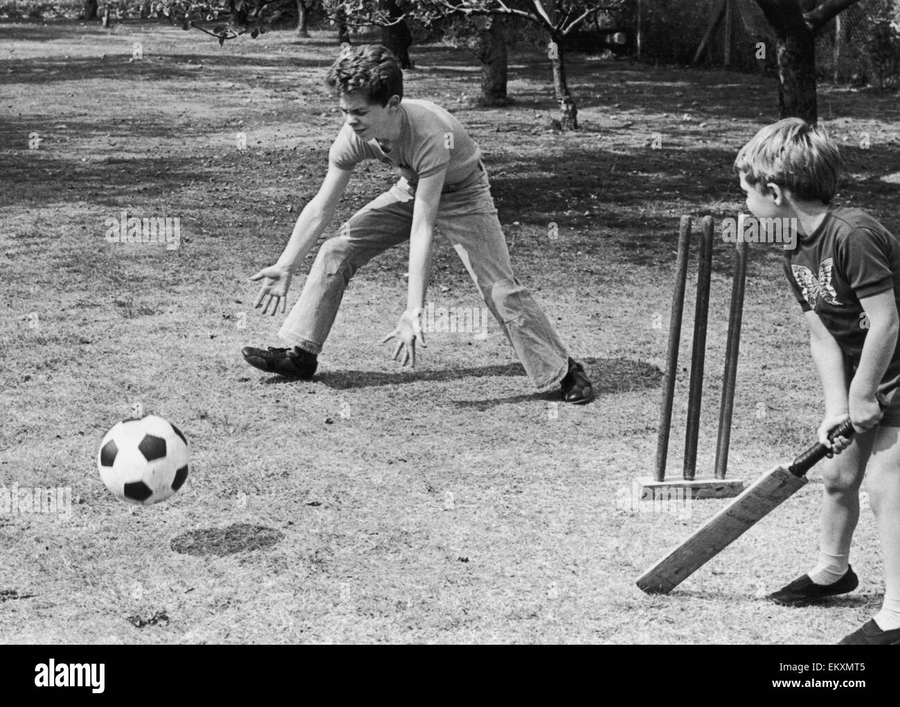 Fourteen year old Stephen Pulley from Chatteris, Cambridge who has been totally blind since he was 14 months old, takes a turn as wicket keeper during a game of cricket with his younger brother Anthony. The ball is filled with ball bearings that rattle wh Stock Photo