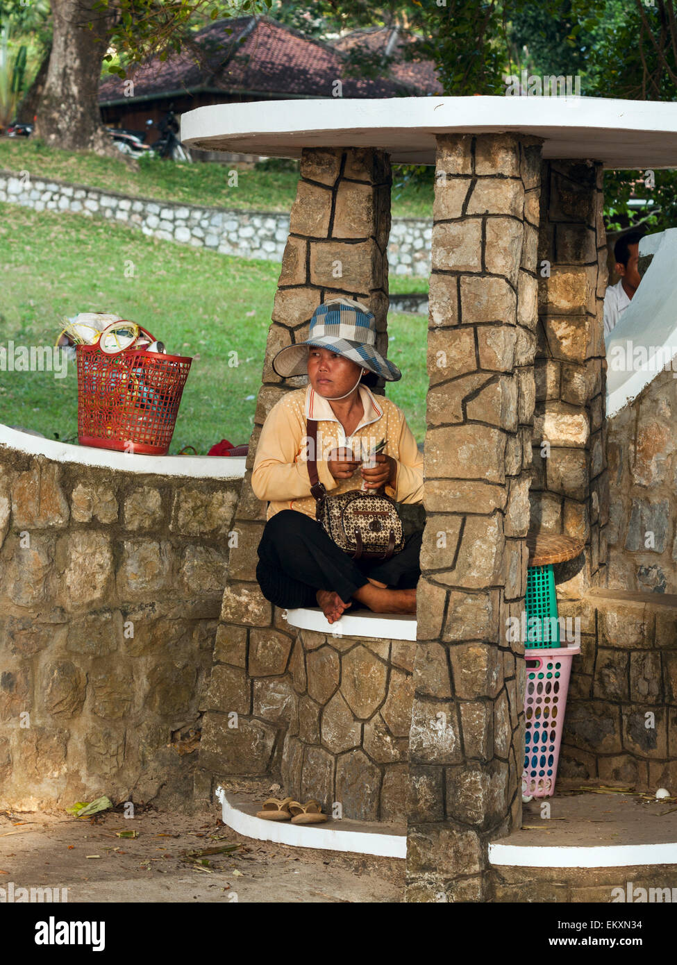 A vendor counting her earned money after hard working day in Kep