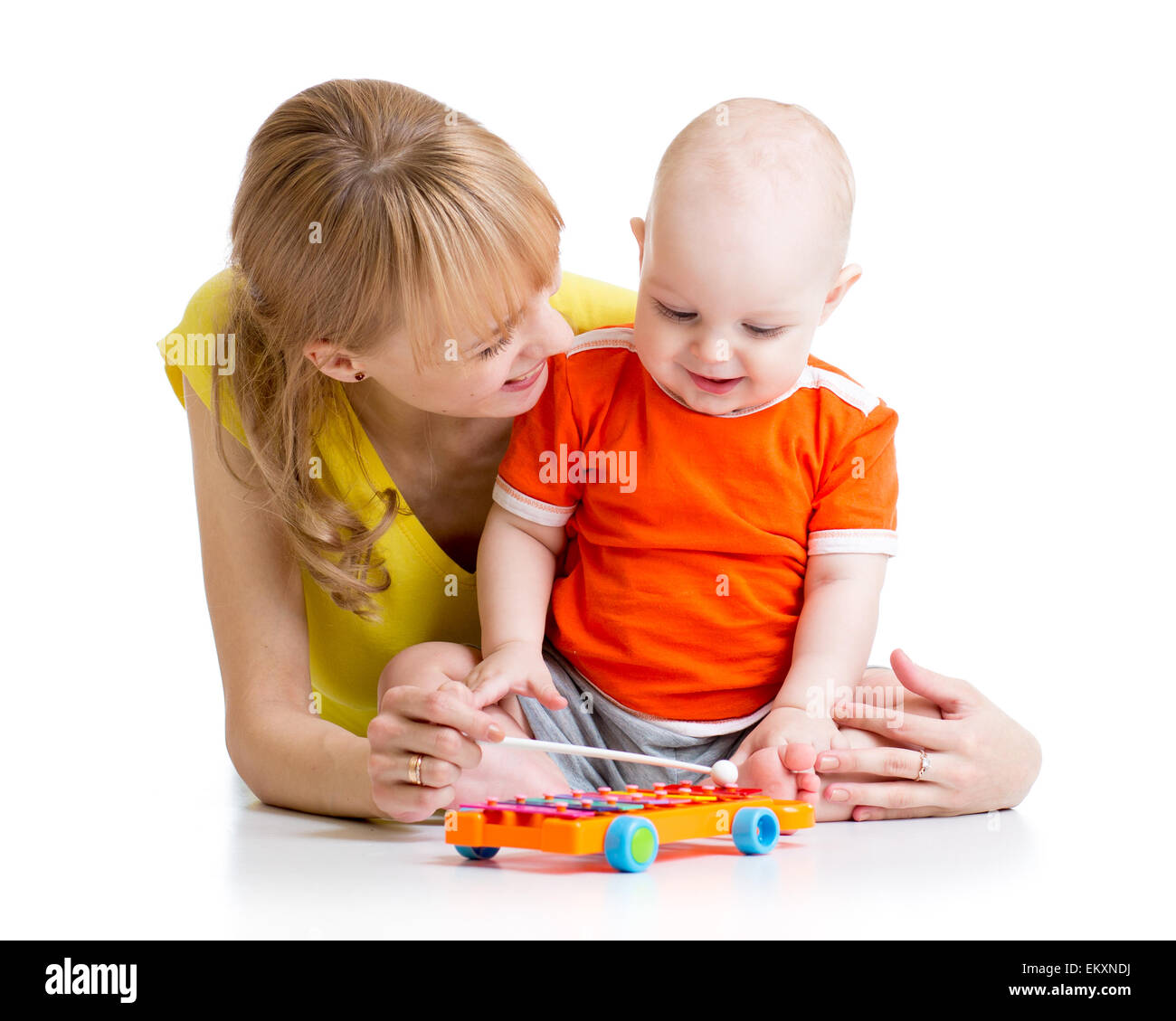 smiling child and mom playing with musical toy Stock Photo