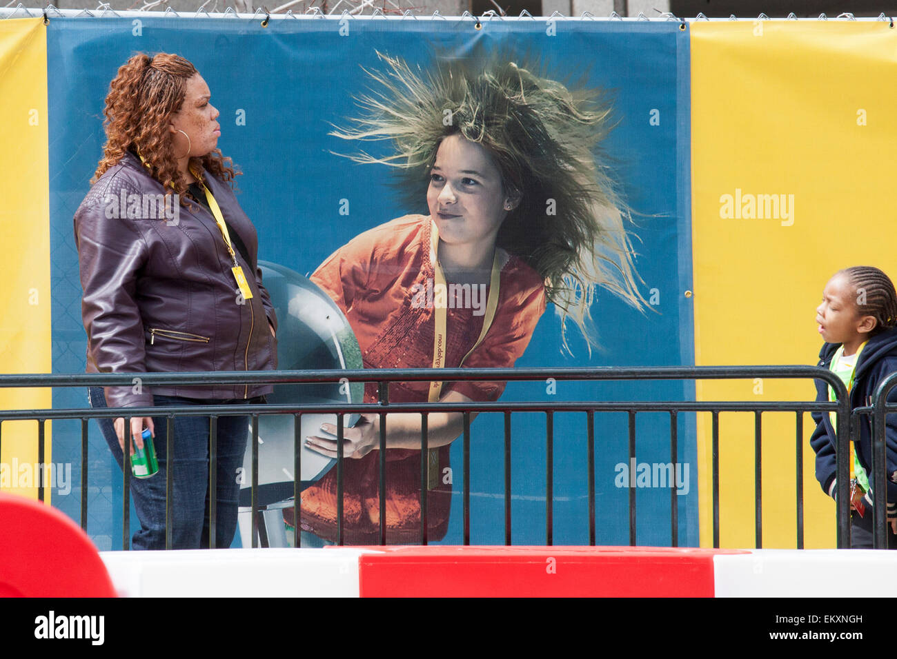 Detroit, Michigan - A woman and her daughter in front of an advertisement on a Detroit street. Stock Photo
