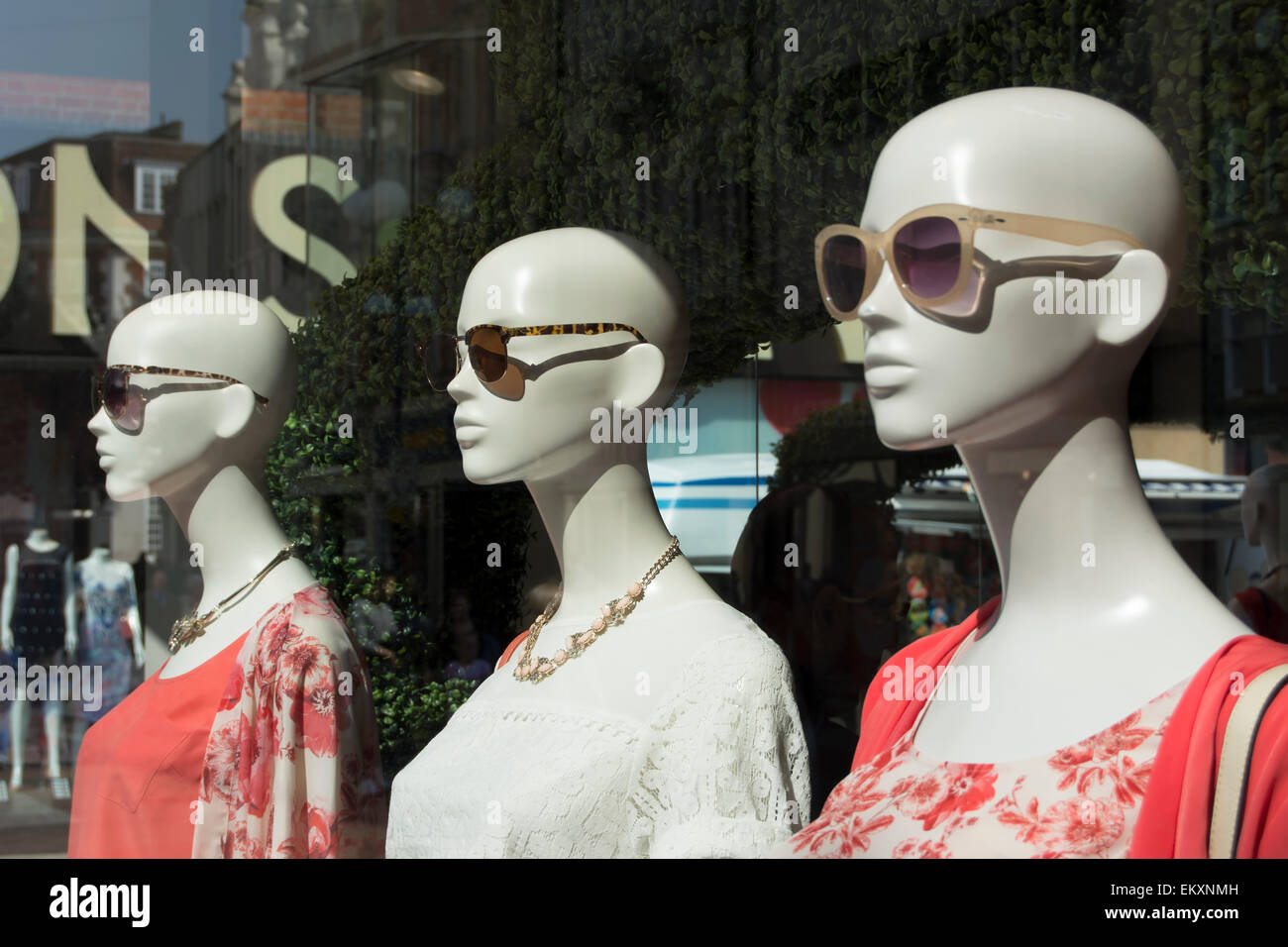 mannequins wearing sunglasses in a clothing shop window in kingston