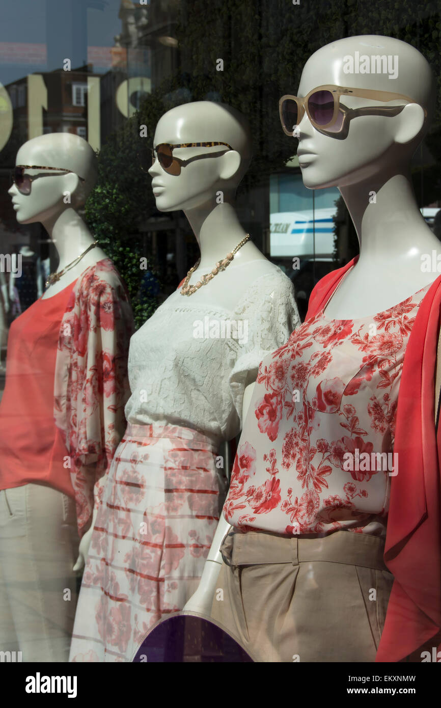 mannequins wearing sunglasses in a clothing shop window in kingston