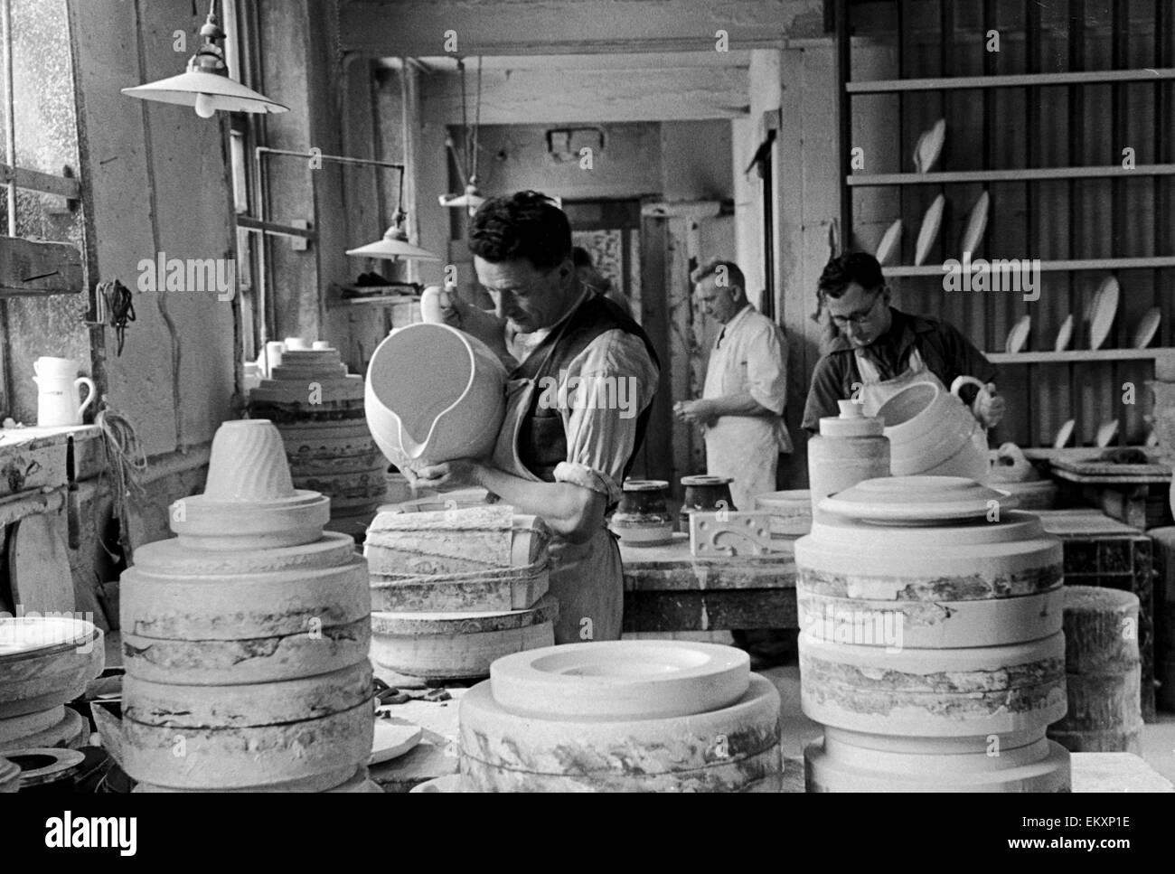 Workers at the Minton China Works in Stoke On Trent, pictured in the mould-making shop where models are cast in plaster-of-paris and the necessary number of moulds made from the originals. 1946. Stock Photo
