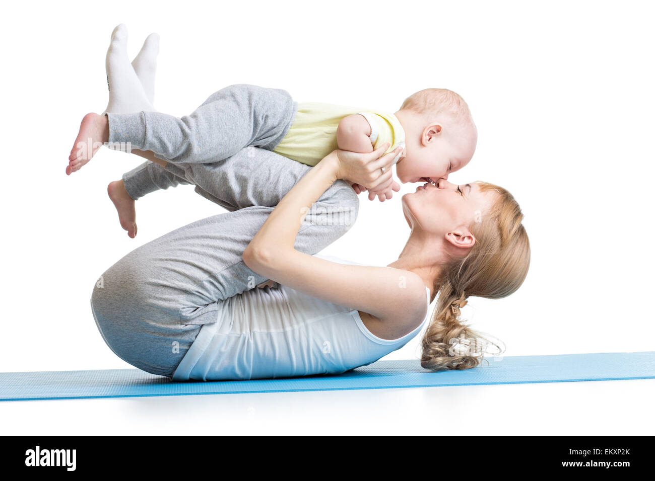 young mother does fitness exercises together with kid boy Stock Photo