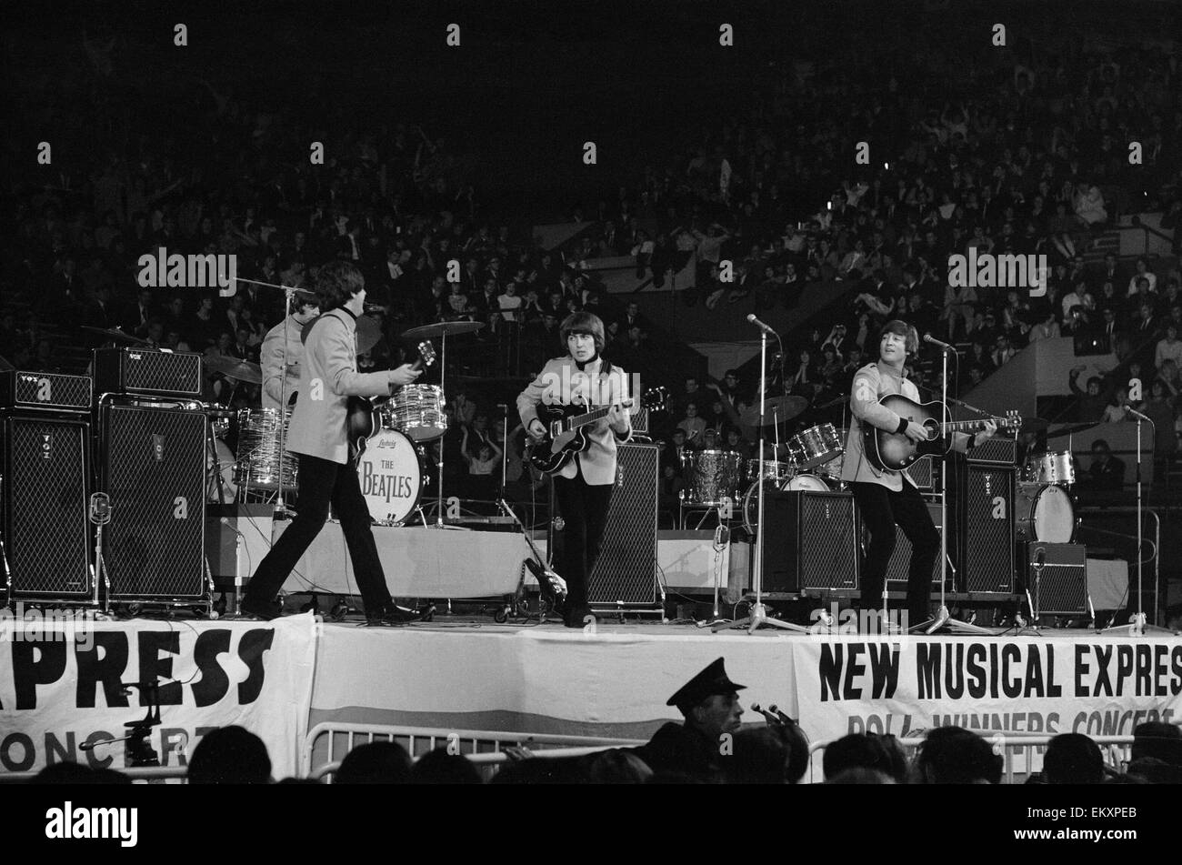 New Musical Express pop concert at Empire Pool Wembley 11th April 1965. The annual IPC New Musical Express concert featured poll winners & guest artists including: The Beatles. Left to right performing on stage: Ringo Starr, Paul McCartney, George Harriso Stock Photo