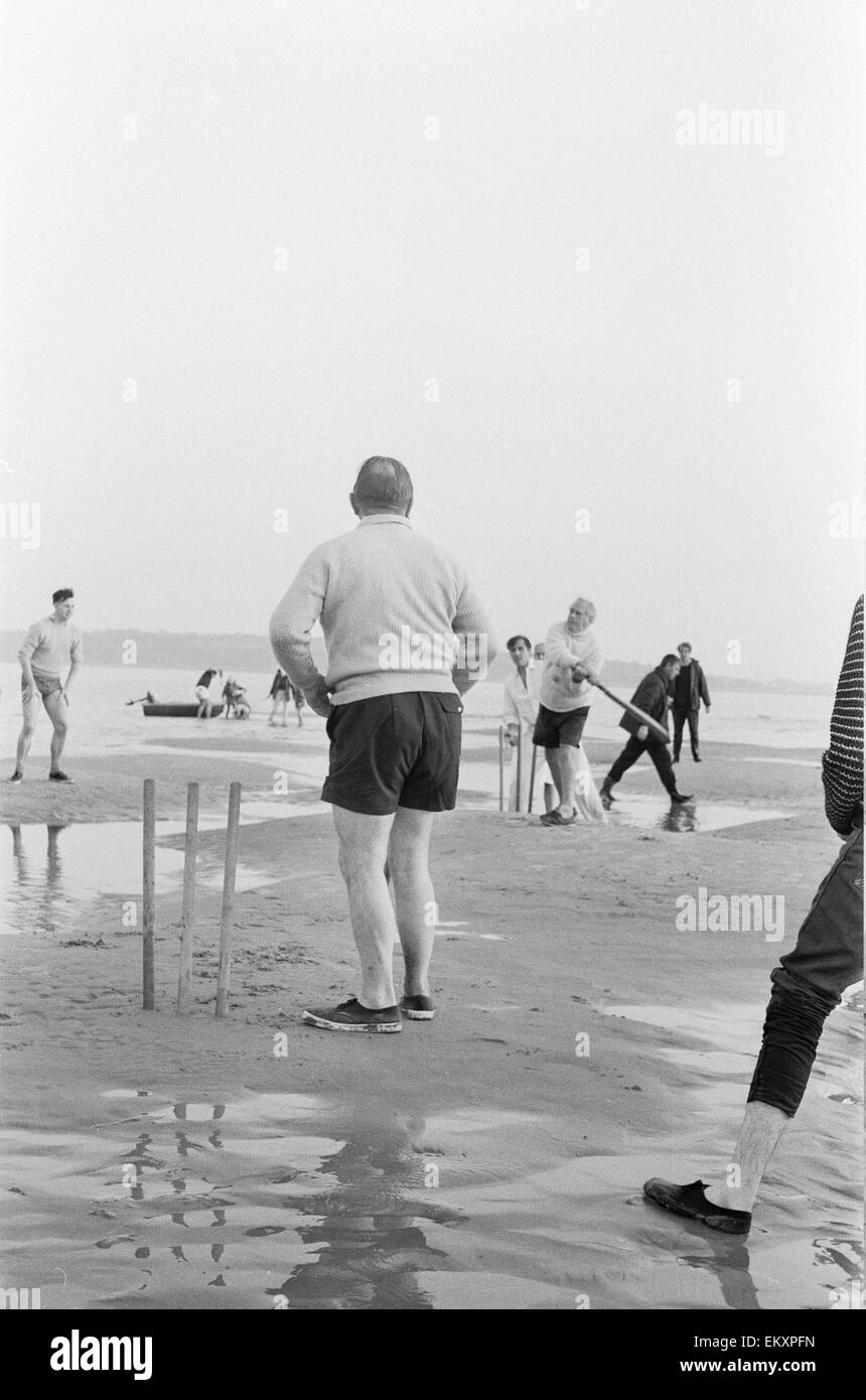 Brambles sandbank cricket match. 'Action' shots from the annual cricket match between the Royal Southern Yacht Club and the Island Sailing Club on a sandbank on the Isle of Wight. 18th September 1966 Stock Photo