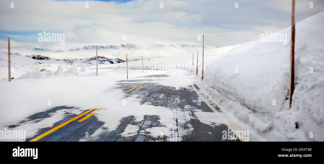 Dangerous snowing road Stock Photo