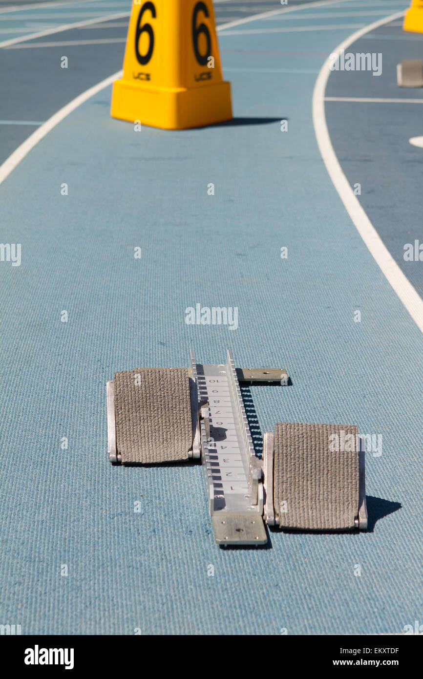 Blue mondo surface running track lanes with starting blocks Stock Photo