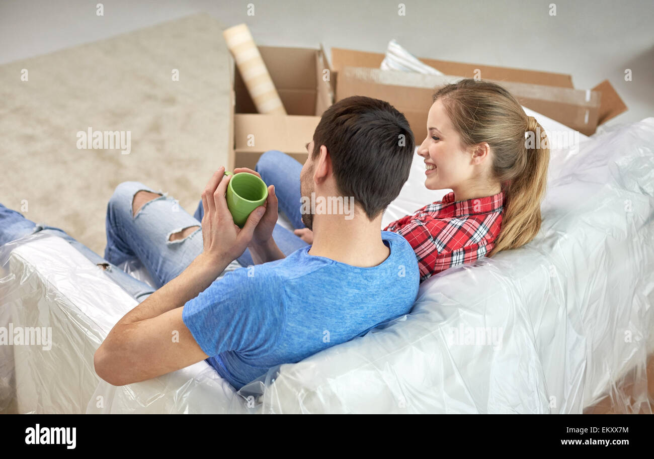 Happy couple relaxing on sofa hi-res stock photography and images - Alamy