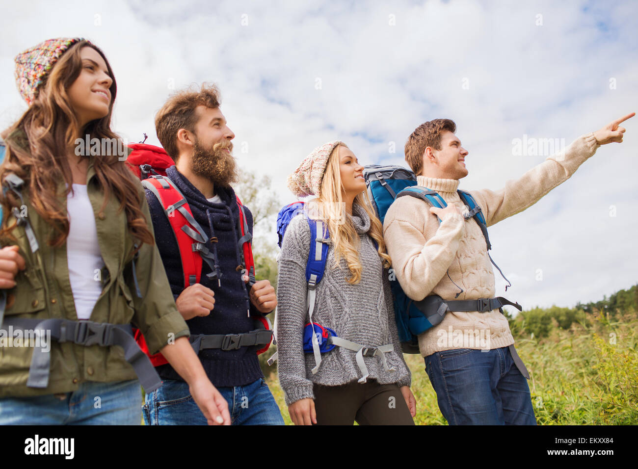 group of smiling friends with backpacks hiking Stock Photo - Alamy