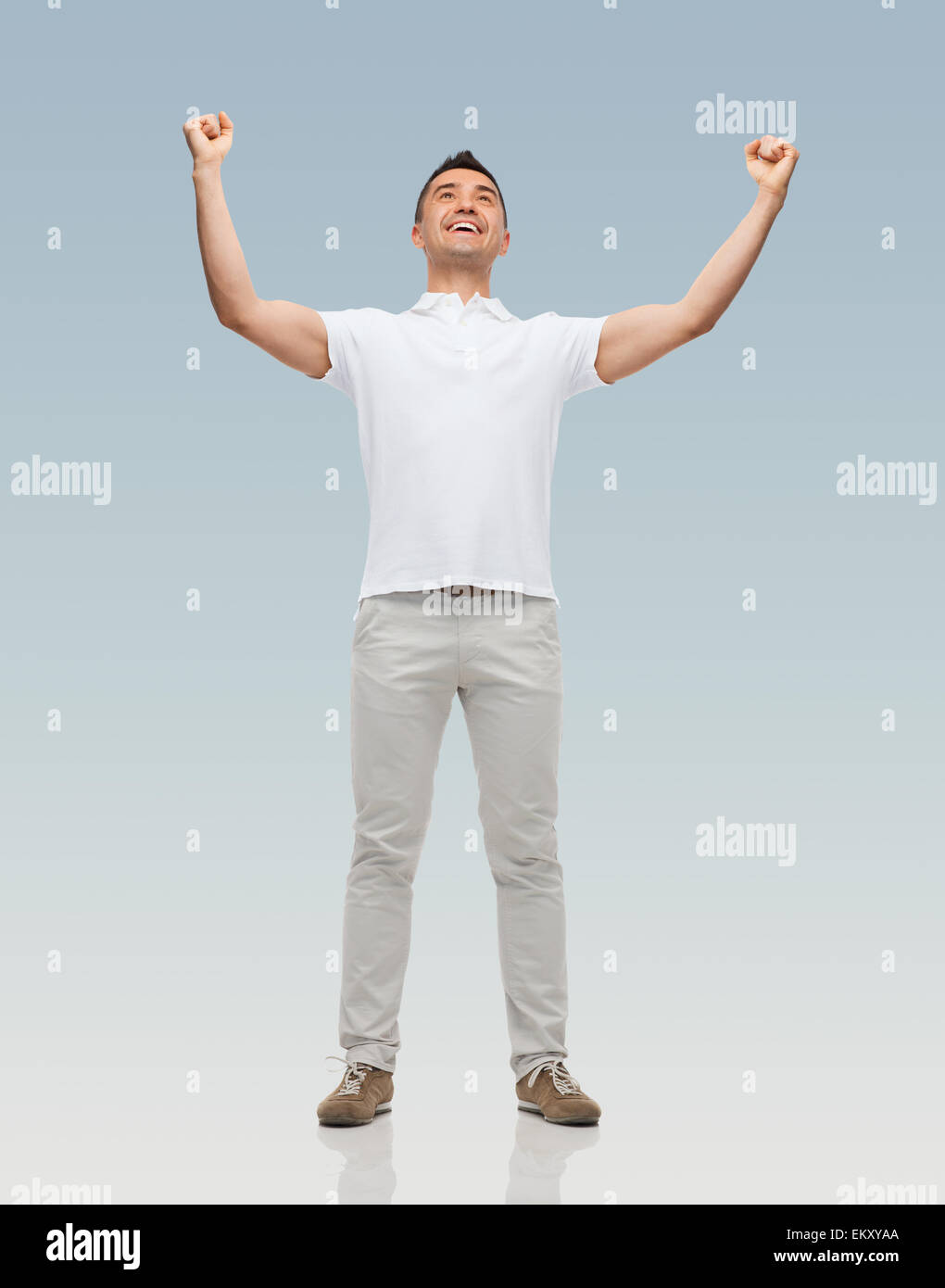 happy man with raised hands over gray background Stock Photo Alamy