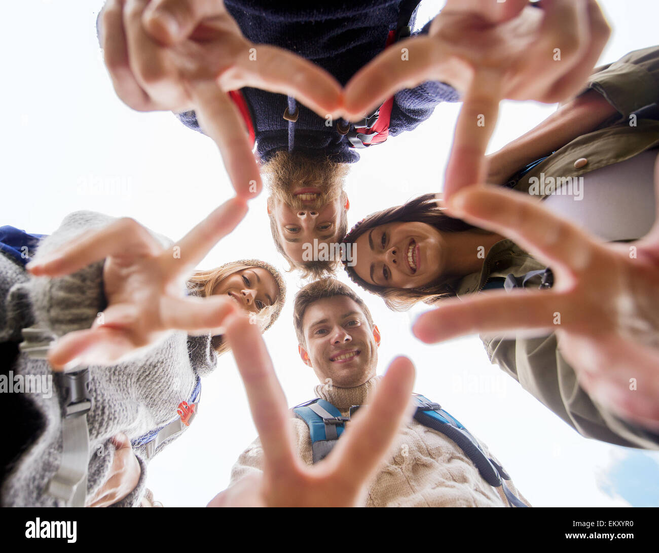 group of smiling friends with backpacks hiking Stock Photo