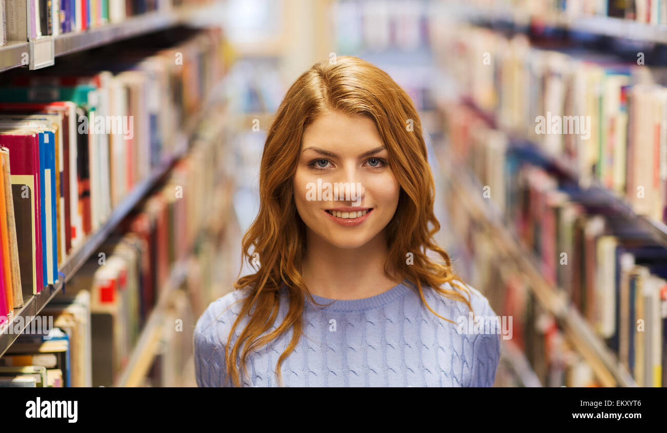 happy student girl or young woman in library Stock Photo - Alamy