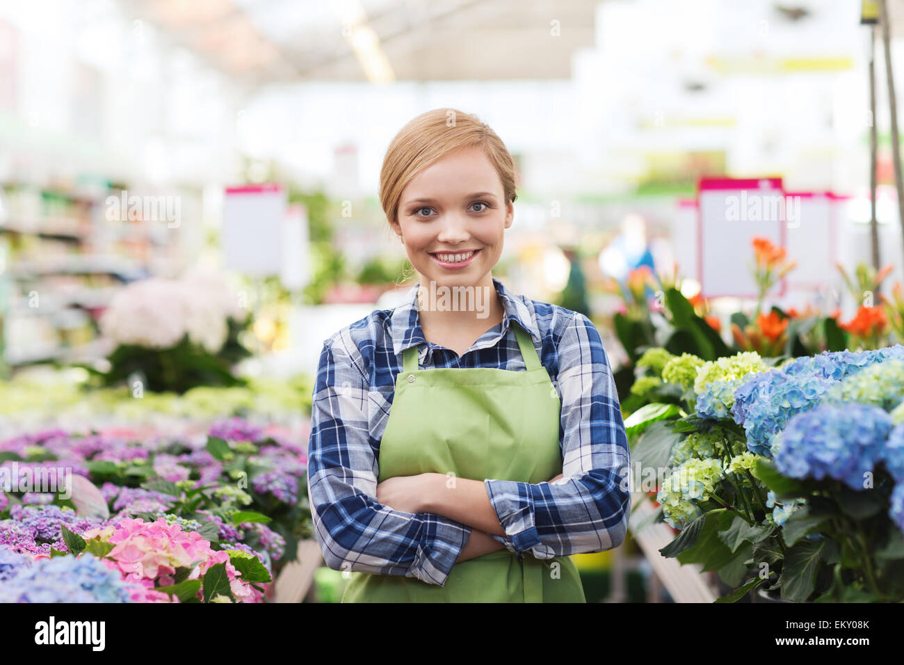 happy woman with flowers in greenhouse Stock Photo - Alamy
