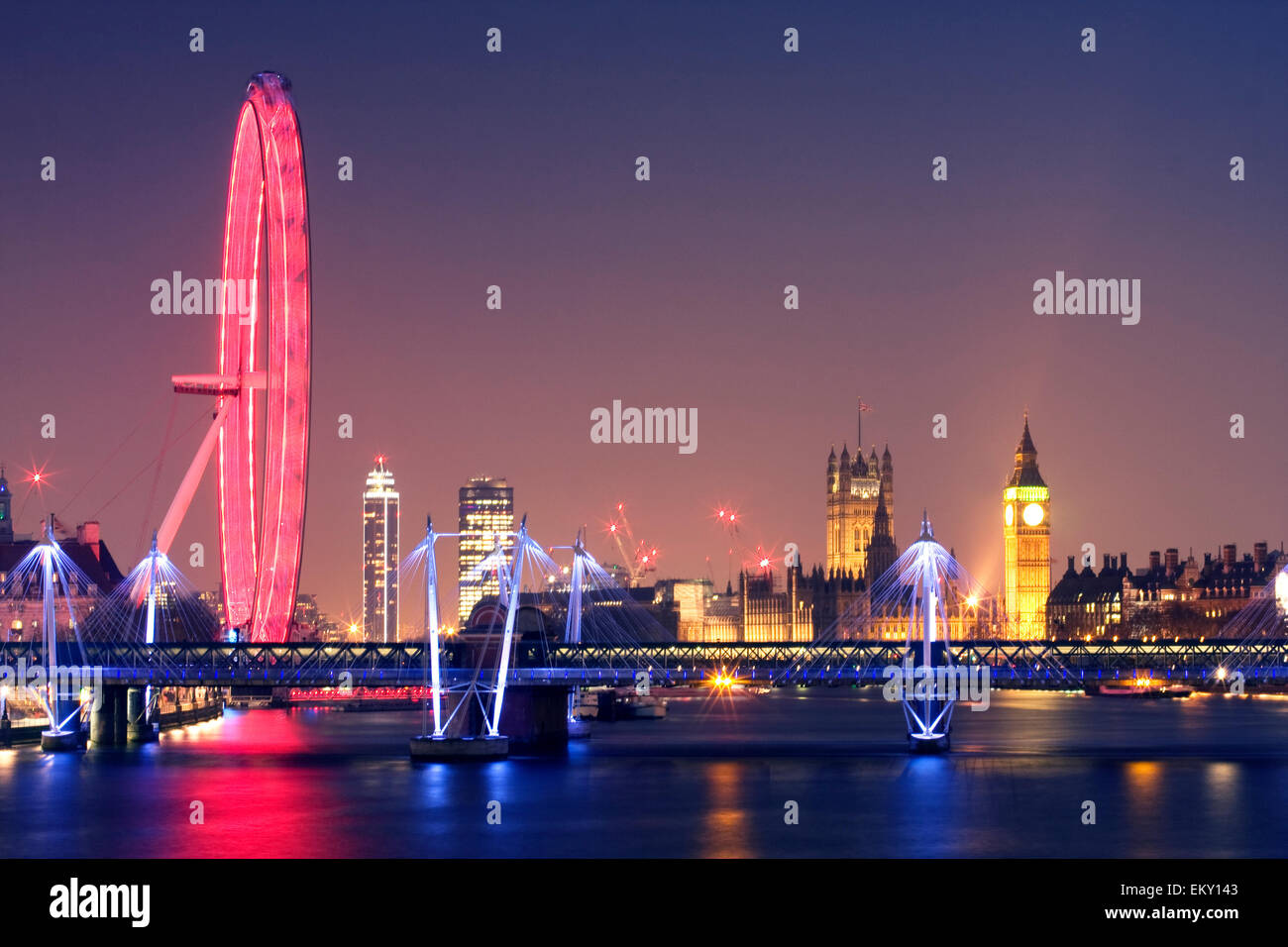 London at night. London Eye Hungerford Bridge and Golden Jubilee Bridges and Palace of Westminster with illuminated Big Ben, UK Stock Photo