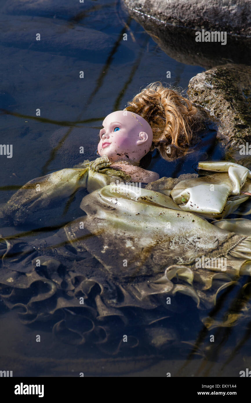 Discarded doll in the Los Angeles River along the Glendale Narrows, Los Angeles, California, USA Stock Photo