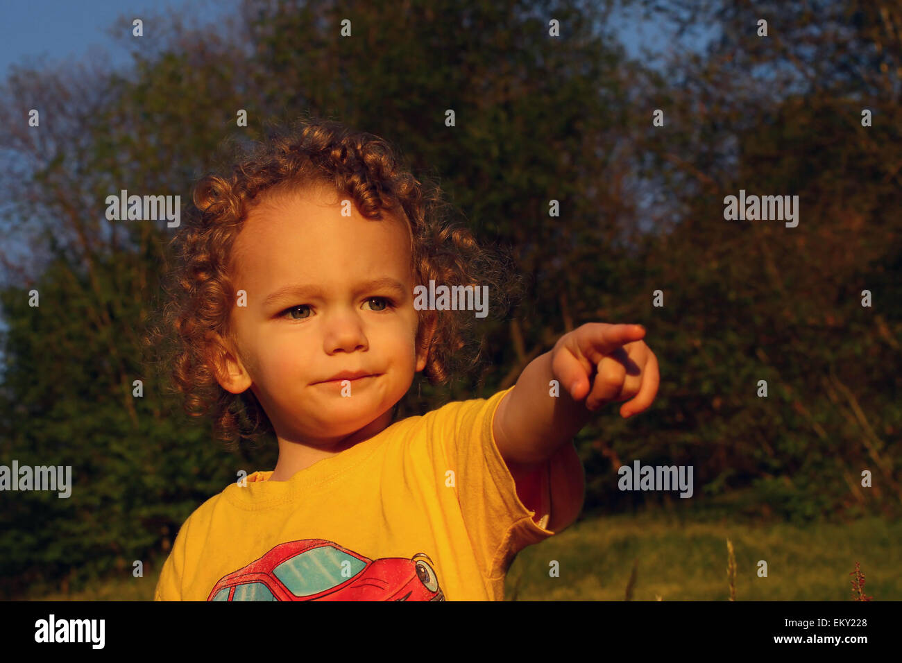 Boy pointing at the sunset Stock Photo - Alamy