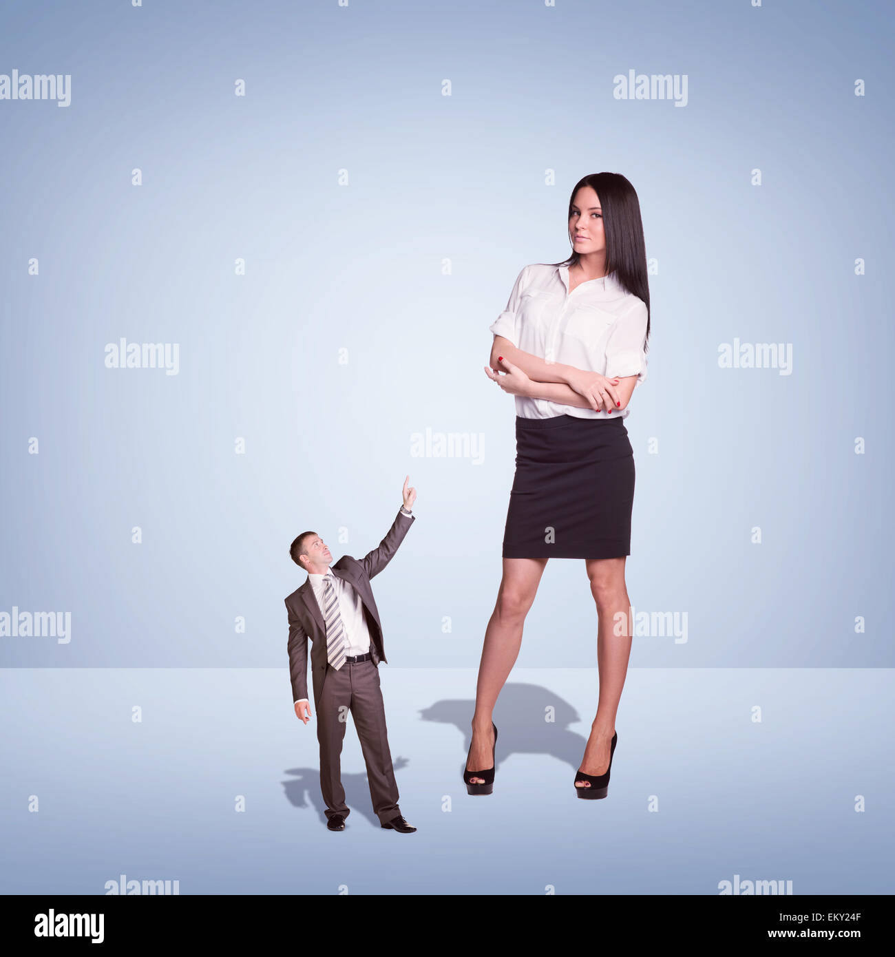 Lagre Young Businesswoman and small Businessman Stock Photo - Alamy