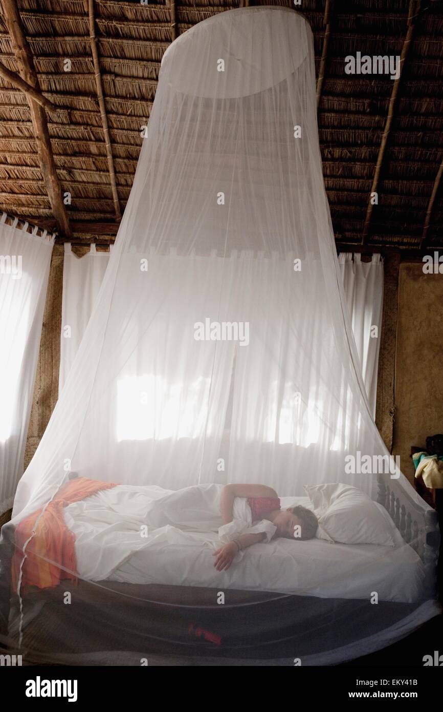 Sleeping under mosquito net hi-res stock photography and images - Alamy