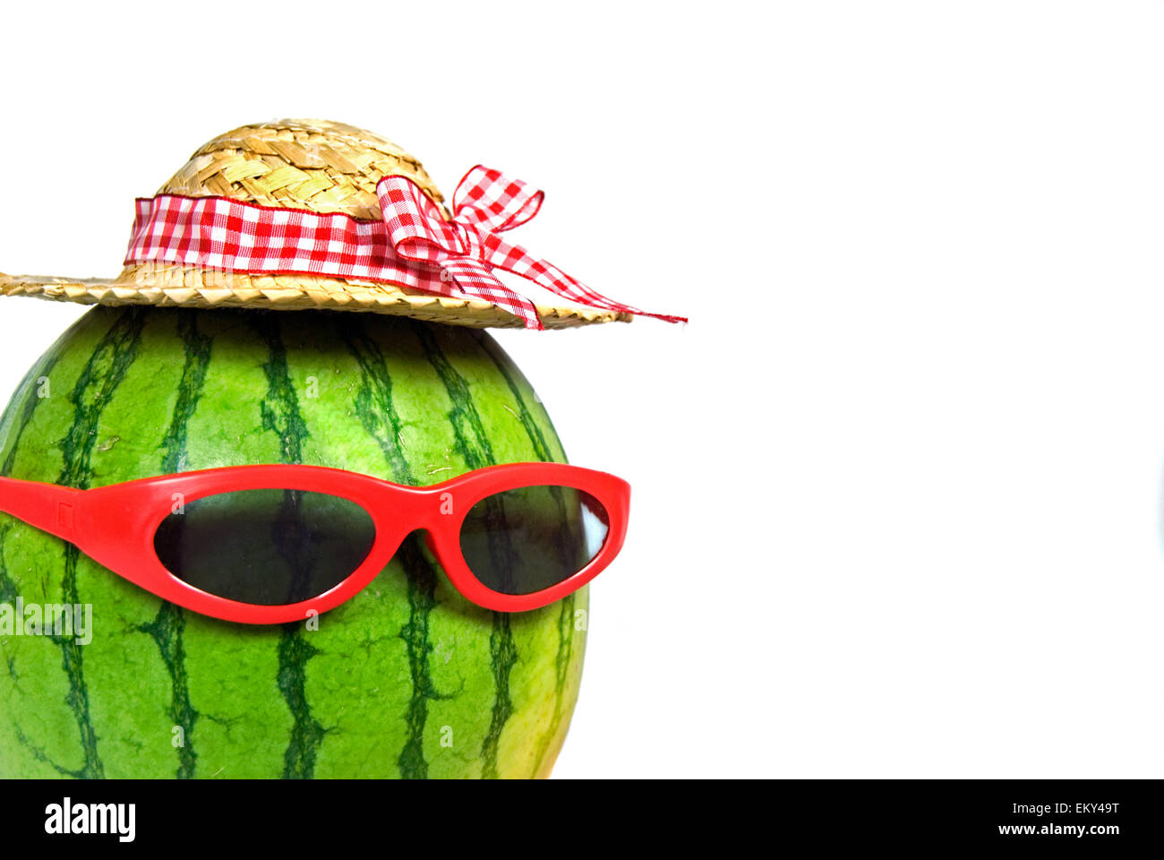 Watermelon with red sunglasses and straw hat isolated on white Stock