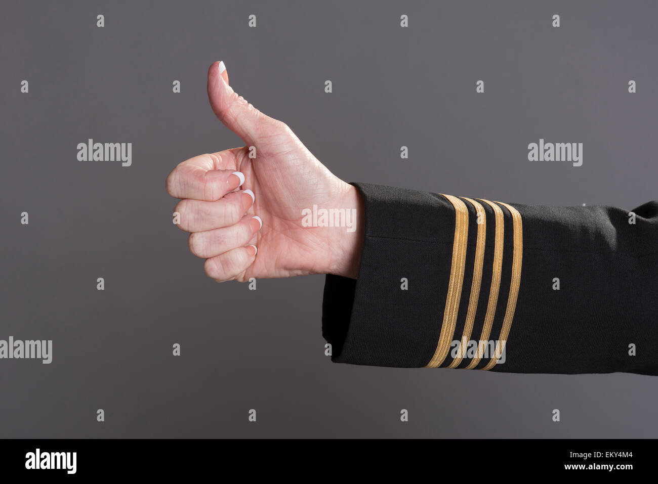 Airline crew member giving thumbs up signal Stock Photo - Alamy