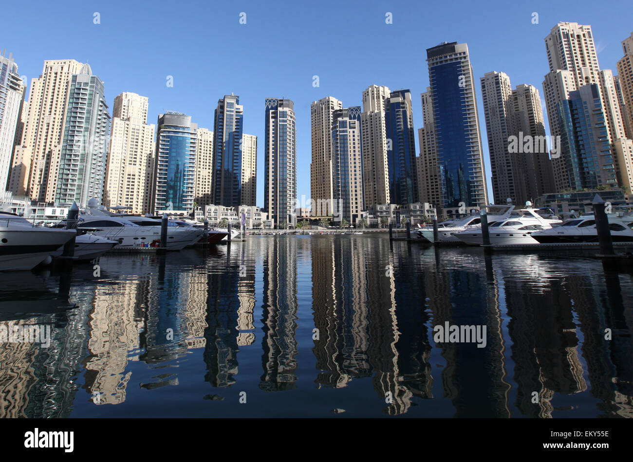 Early morning sunlight reflects against the skyline of  skyscrapers at Dubai Marina Stock Photo