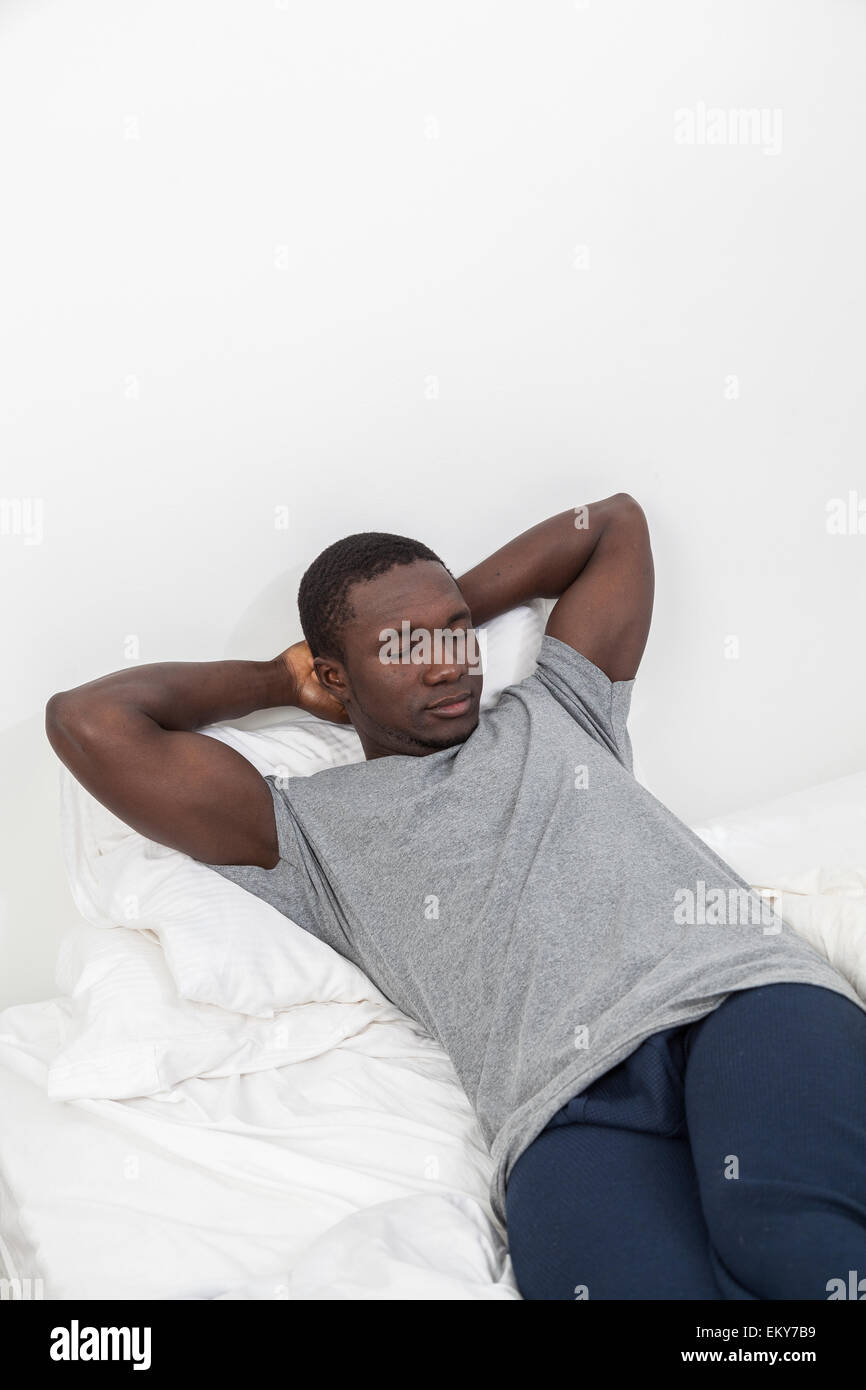 Black man lying on the bed Stock Photo Alamy