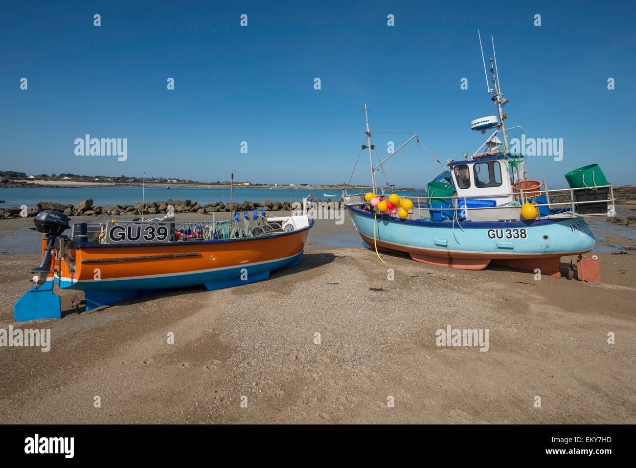 Fishing boats dried out on a sandy beach at low tide. Stock Photo