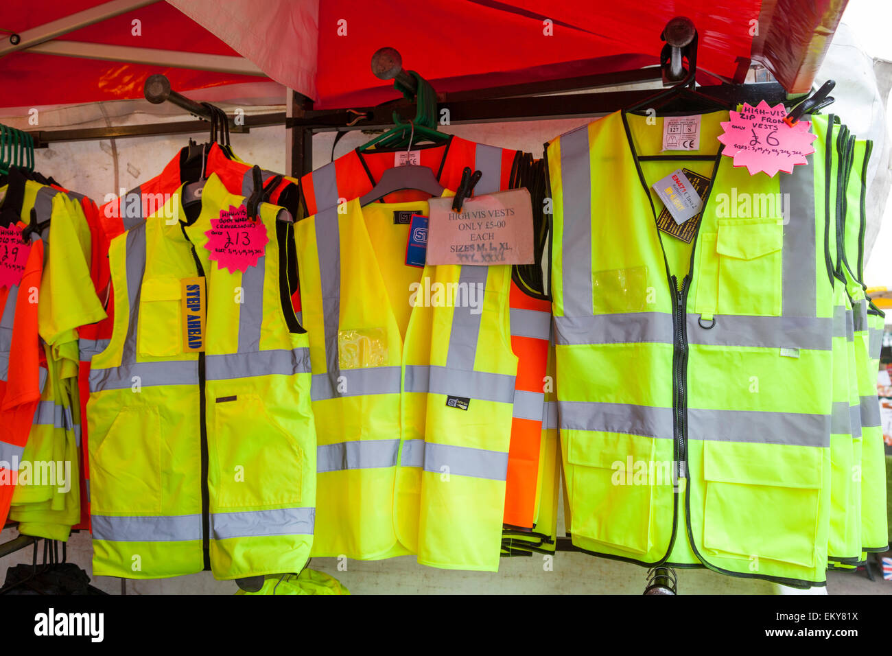 Hi-viz jackets and vests for sale hanging in a market stall, Loughborough. Stock Photo