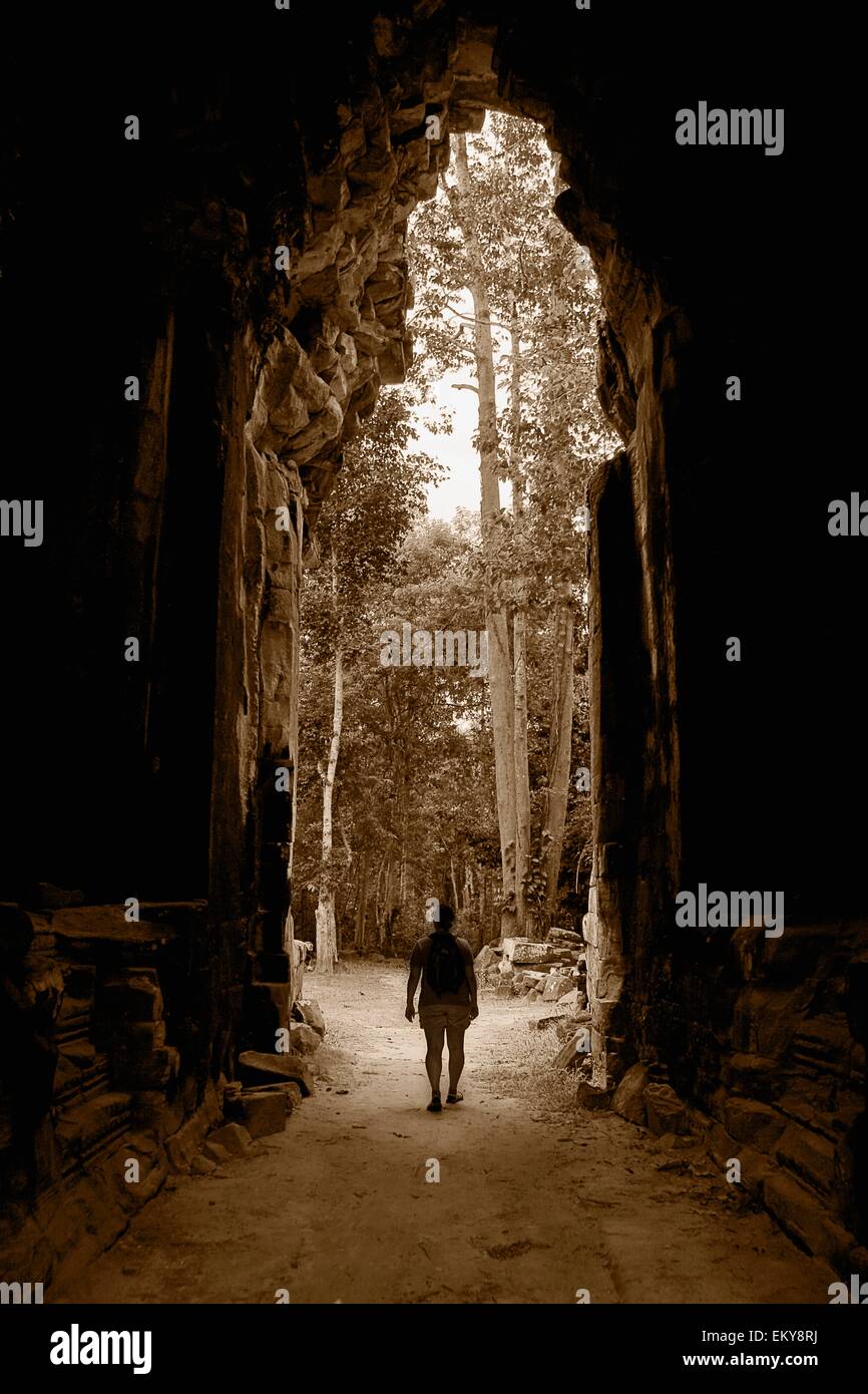 A Person Walking Through A Temple In Asia Stock Photo