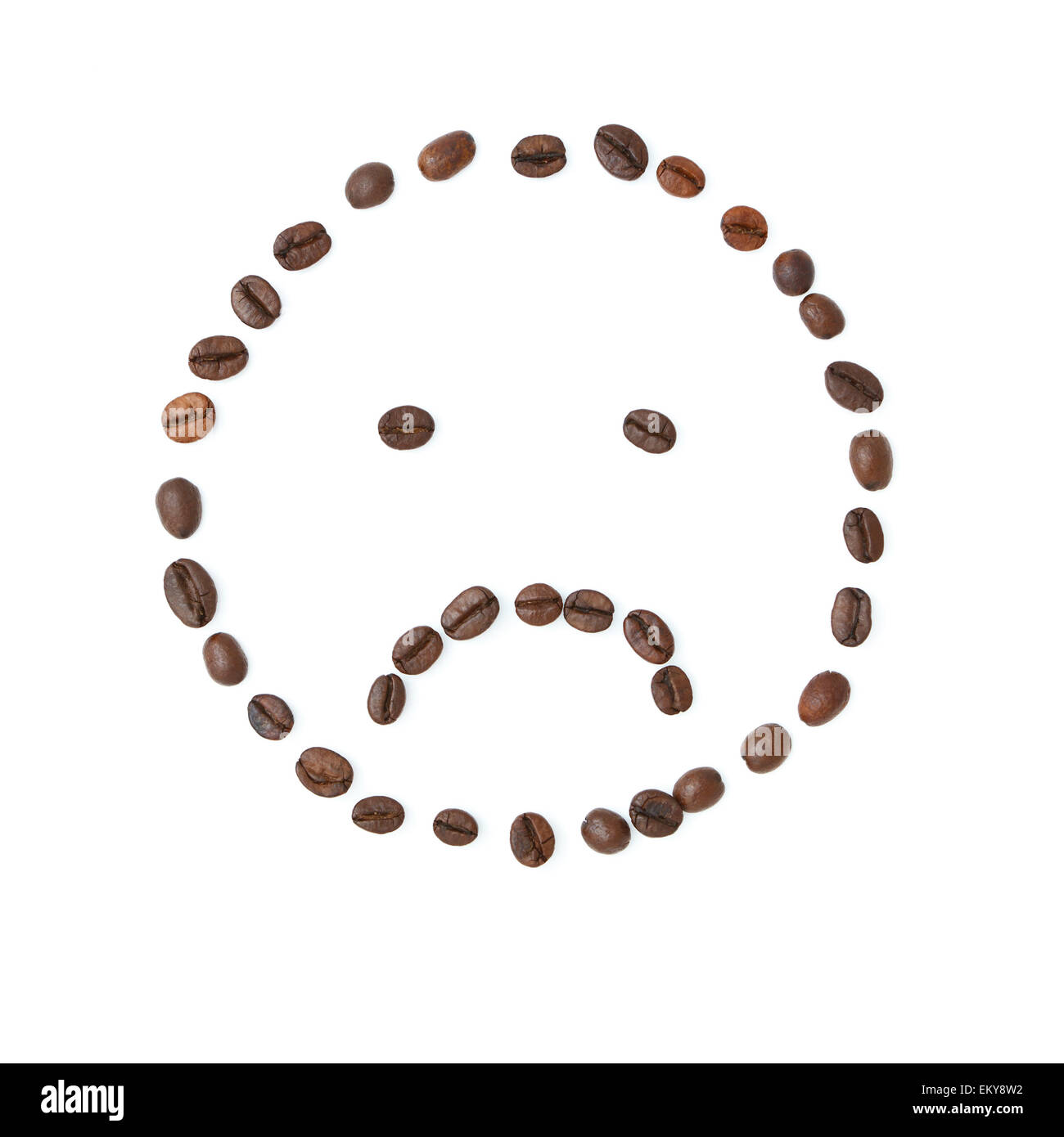 Very sad emoticon made of coffee beans isolated on white background studio shot Stock Photo