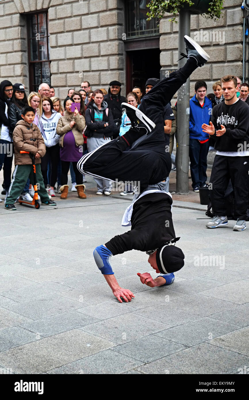 A young male Break dancer performing in front of large crowd in Henry street Dublin Ireland Stock Photo