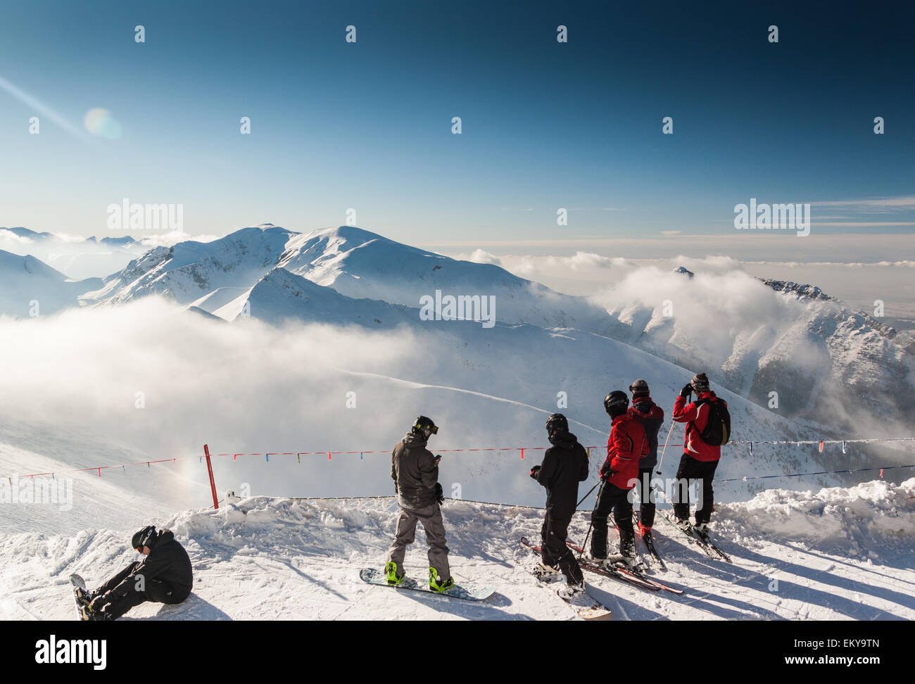 Skiers and Snowboarders and Western Tatras visible from Kasprowy Wierch, southern Poland Stock Photo