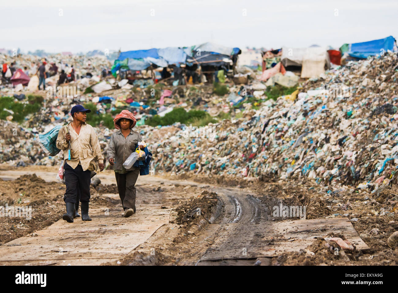 Cambodia, People make their way into trash dump; Phnom Penh Stock Photo