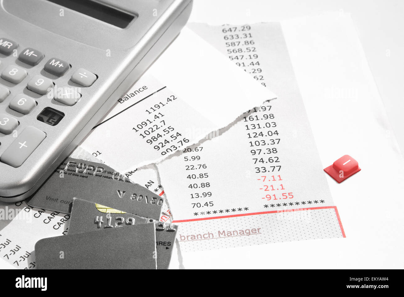 bank statement and credit card cut into little pieces and a broken