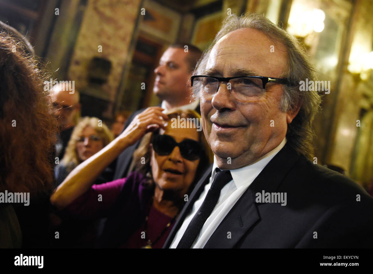 Montevideo, Uruguay. 14th Apr, 2015. The widow of Uruguayan writer Eduardo Galeano, Helena Villagra (L) and the Spanish singer Joan Manuel Serrat, react during the tribute to Eduardo Galeano organized by the government of Uruguay, in the Hall of Lost Steps of the Legislative Palace, in Montevideo, capital of Uruguay, on April 14, 2015. According to local press, Eduardo Galeano, author of 'The Open Veins of Latin America' (1971), died on Monday in Montevideo at the age of 74 years as a result of lung cancer. Galeano's body will be cremated on Wednesday. Credit:  Nicolas Celaya/Xinhua/Alamy Live Stock Photo