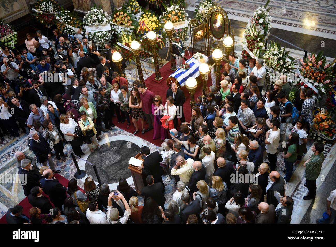 Montevideo, Uruguay. 14th Apr, 2015. People gather around the coffin of Uruguayan writer Eduardo Galeano, during the tribute organized by the government of Uruguay, in the Hall of Lost Steps of the Legislative Palace, in Montevideo, capital of Uruguay, on April 14, 2015. According to local press, Eduardo Galeano, author of 'The Open Veins of Latin America' (1971), died on Monday in Montevideo at the age of 74 years as a result of lung cancer. Galeano's body will be cremated on Wednesday. Credit:  Nicolas Celaya/Xinhua/Alamy Live News Stock Photo