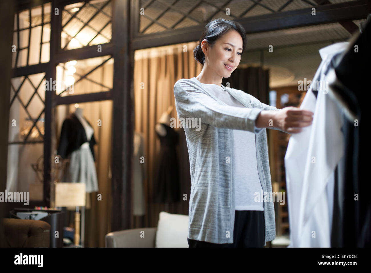 Clothing store owner checking clothes Stock Photo Alamy