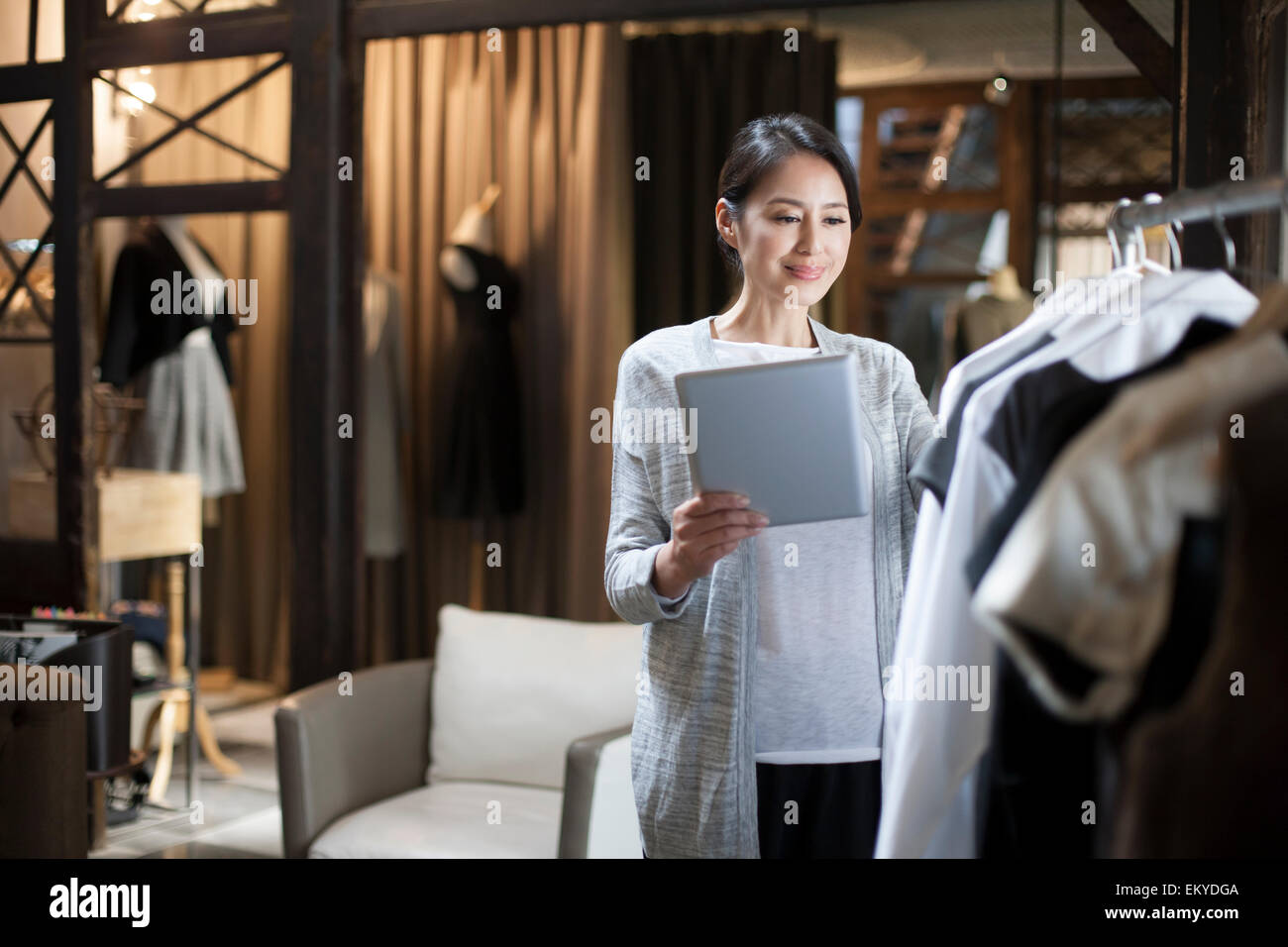 Clothing store owner with digital tablet Stock Photo Alamy