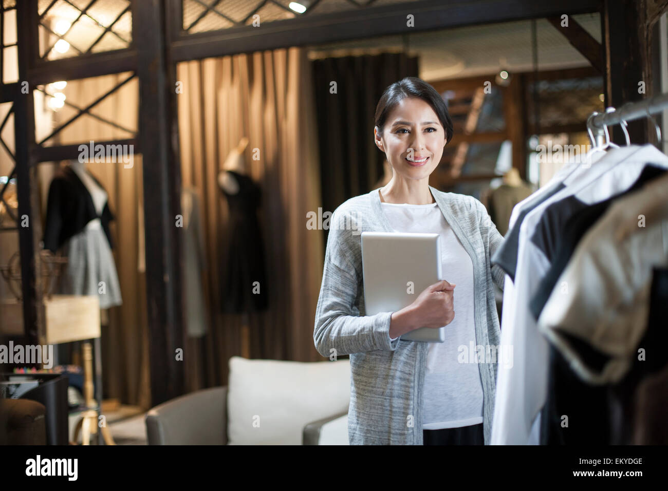 Clothing store owner with digital tablet Stock Photo Alamy
