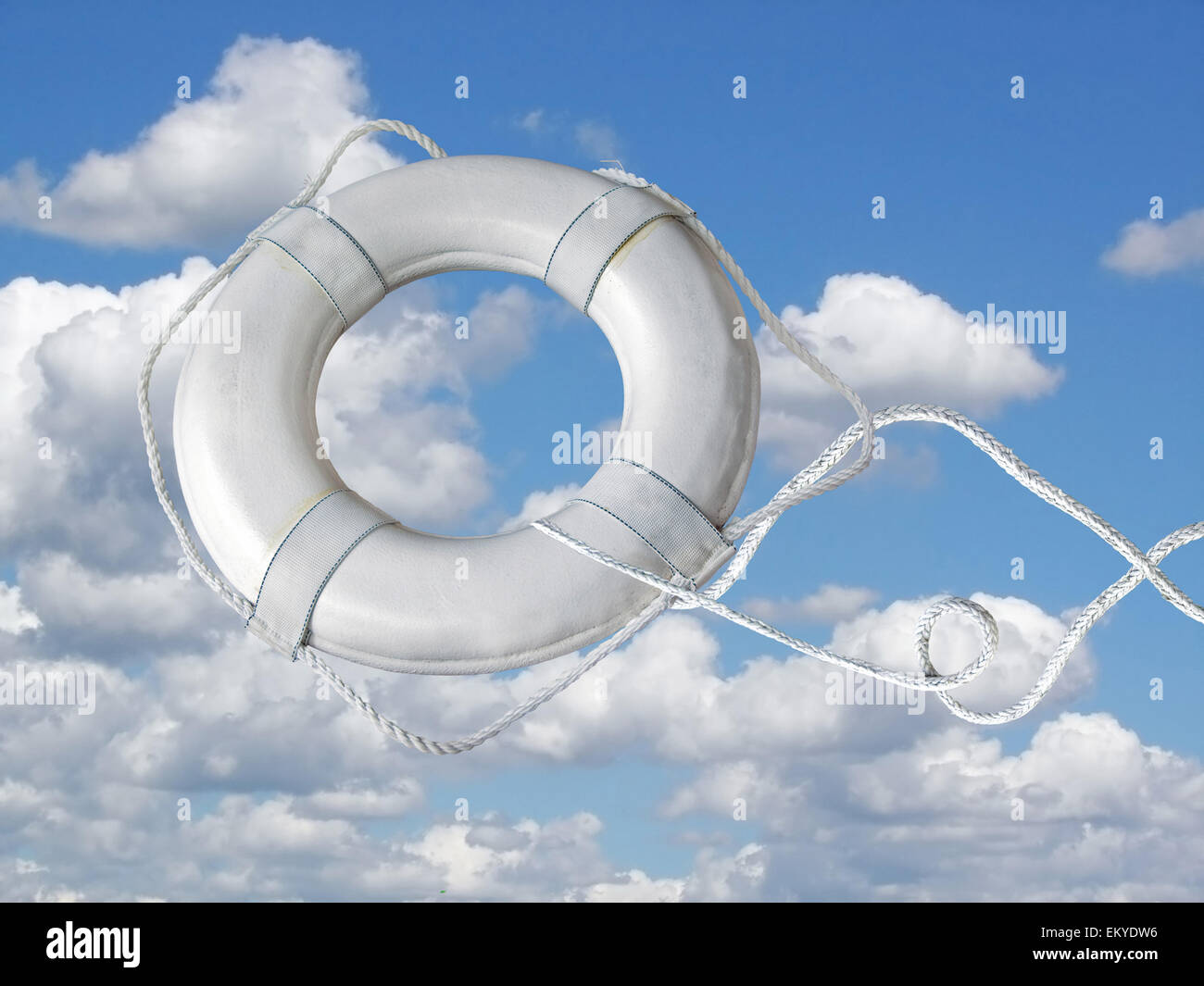 White life ring with rope airborne in sky and clouds. Stock Photo