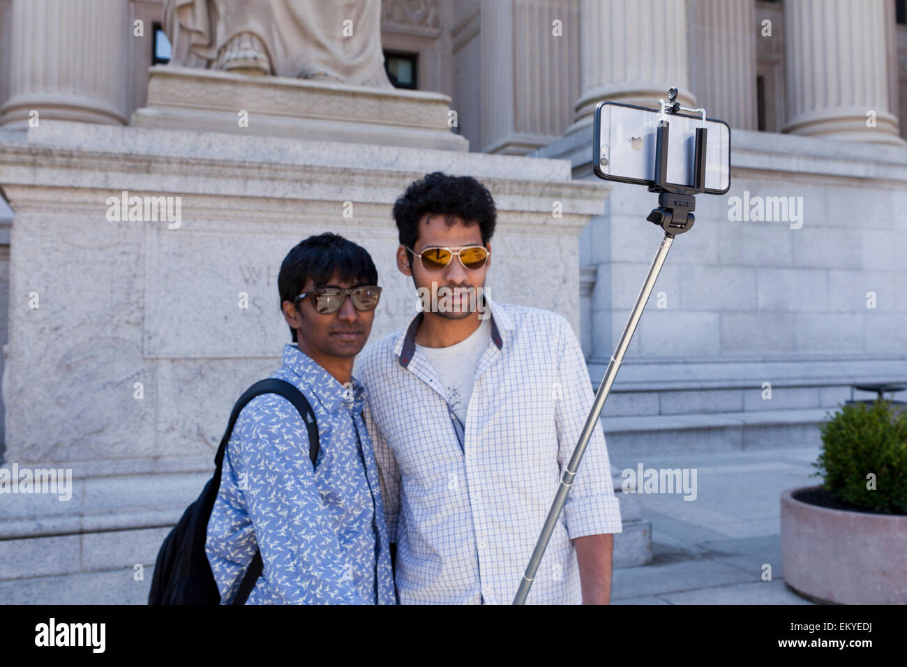 Two male friends taking picture with selfie stick - USA Stock Photo